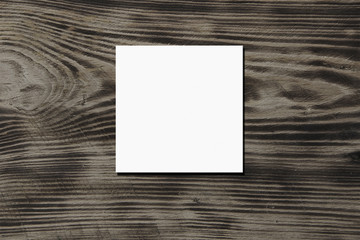 Empty square canvas frame on a wooden background. Mock up poster.