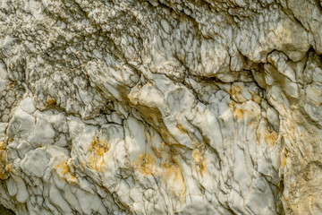 natural white rock wall structure with yellow spots