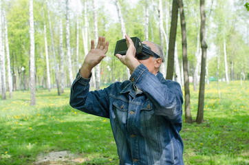 Aged man is using virtual glasses 