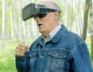 Aged man is using virtual glasses 