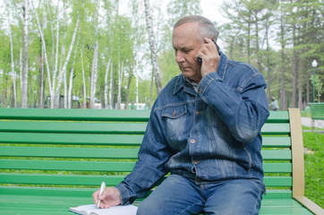 Fototapeta premium Aged man is using cellphone