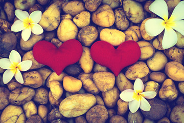 red heart on the rock and Frangipani flowers