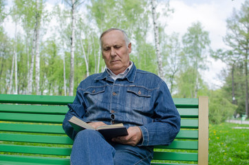 Fototapeta premium Aged man is reding the book