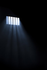Light coming through a barred window with fog