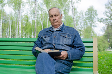 Fototapeta premium Aged man is reding the book
