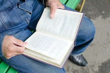 Naklejka premium Aged man is reding the book
