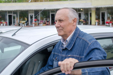 Aged man  sitting in the car