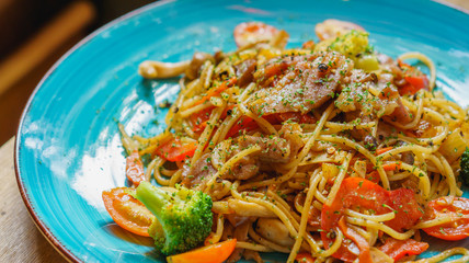 Spaghetti on blue dish with high key.