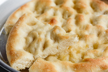 A sliced focaccia in the pan