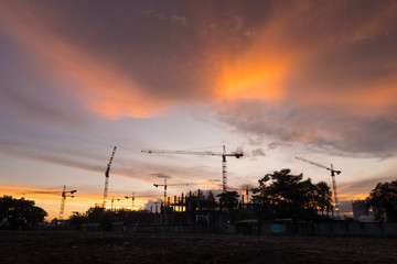siluate of tower crane on high building