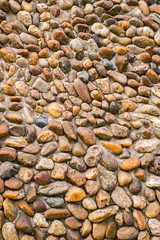 Pebbles stone wall background, closeup view