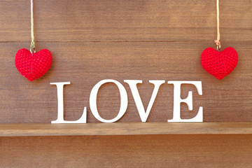 words " love " and heart shaped fabric