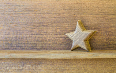 wood star on wood shelf