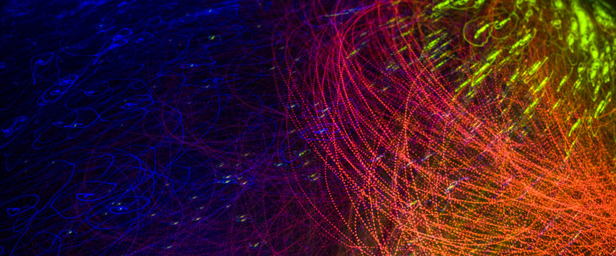 Playing with optical fibers light on black background © Roberto Sorin
