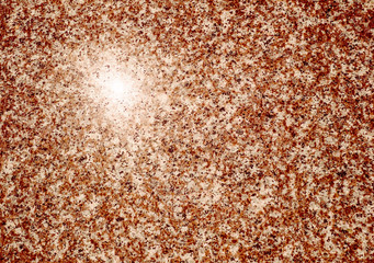 Red granite stone with sun light reflection