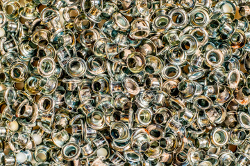 Rusty silver brass eyelet background, closeup view