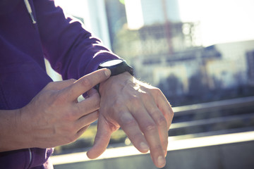 runner man checking heart rate with watch and trainer