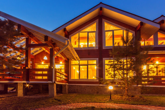 New Log Home with Large Porch at dusk