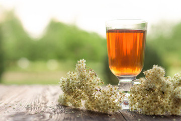 Glass of tea on table with herbs