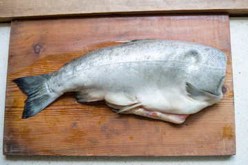 Fresh fish on wooden cutting board