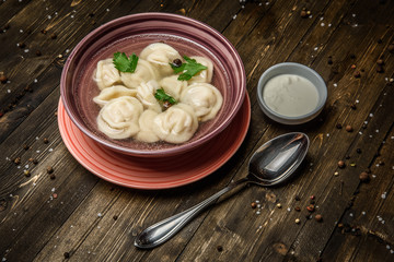dumplings in broth on a wooden background