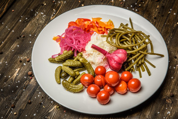 Pickled vegetables on the wooden background