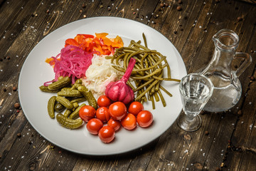 Pickled vegetables on the wooden background