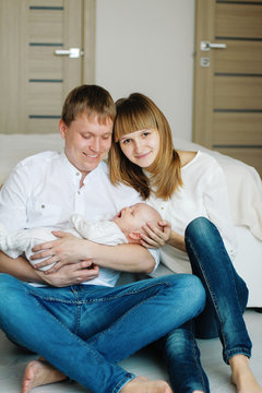 happy young family with a baby on the floor