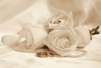 Wedding rings and roses as wedding background. In Sepia toned. R