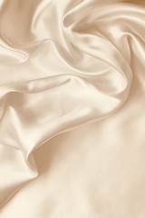 Smooth elegant golden silk as wedding background. In Sepia toned