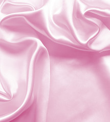 Smooth elegant pink silk or satin texture as background