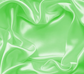 Smooth elegant green silk or satin texture as background