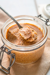 Natural Almond Butter in a Glass Jar with Spoon