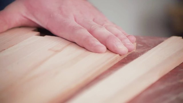 hand-held belt sander at finished wood furniture
