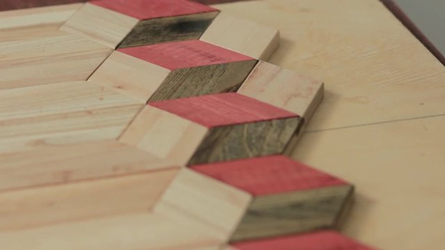 workman makes a pattern of wooden parts