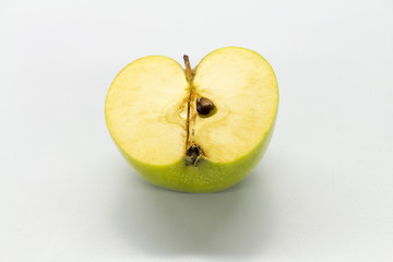 Sliced green apples on a white table.