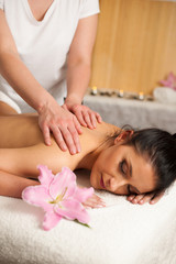 Fototapeta na wymiar Beautifulyoung woman having a rejuvenating massage in a wellness