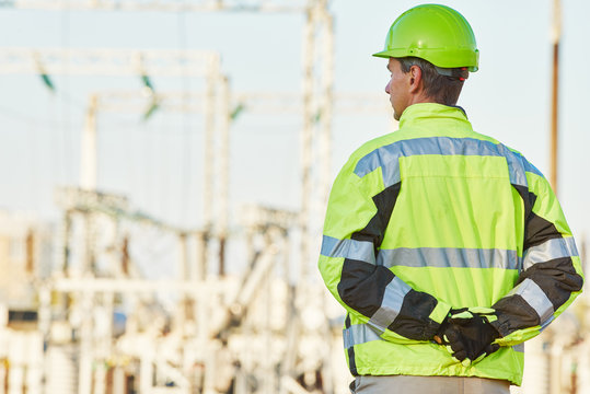 Service engineer standing in front of electro power plant