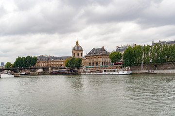 PARIS, FRANCE, MAY 16 2005. Bridge of arts, before fashion put padlocks on railings. In the background the Mazarin Library with the Academy of Fine Arts . View from the Sena River
