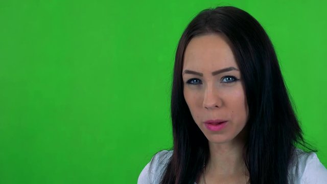 young pretty woman does crazy faces (grimaces) - green screen - studio 