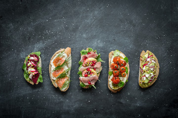 Different kinds of colorful sandwiches on black © pinkyone