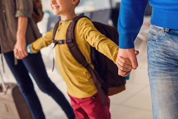 Happy family with suitcases in airport