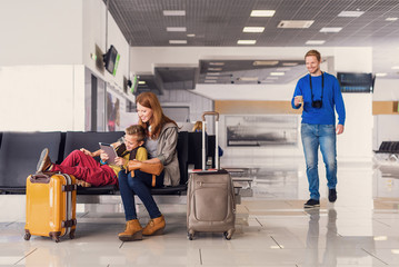 Family waiting for departure at airport