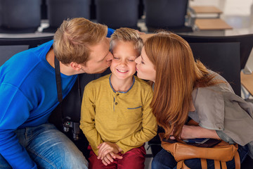 Fototapeta premium Happy family hugging at airport