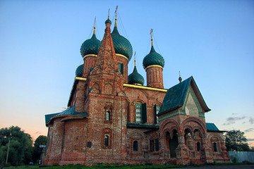 Fototapeta na wymiar old beautiful red-brick Russian Orthodox Church with its green d