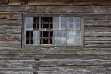 Part of the wooden wall  old house with broken windows and pine frame