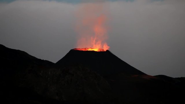 La Reunion Piton de la Fournaise volcano eruption at night with lavaflow