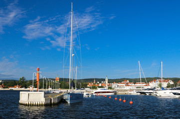 Fototapeta premium The longest wooden mall in Europe. View of the city and the waterfront. Ships and boats.
