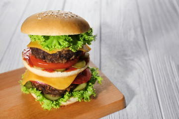 Tasty burger on wooden board