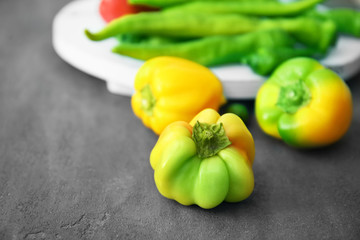 Different sorts of pepper on gray background